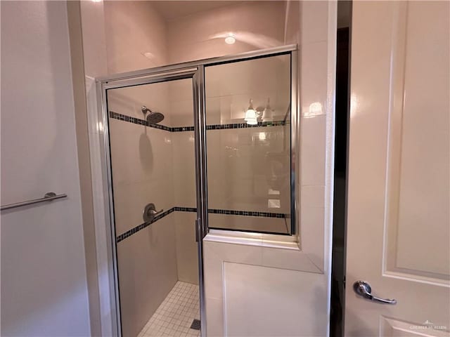 bathroom with a shower with door