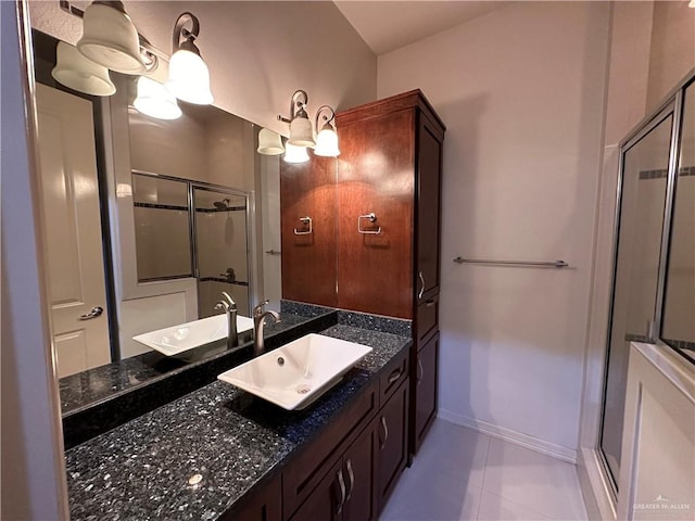 bathroom with vanity, tile patterned floors, and a shower with door