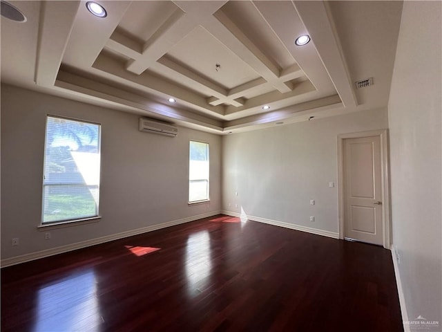 unfurnished room featuring a wealth of natural light, hardwood / wood-style floors, and a wall mounted air conditioner