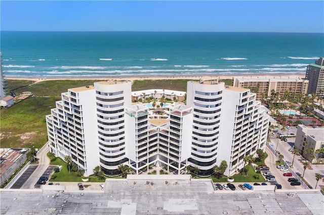 drone / aerial view featuring a water view and a view of the beach