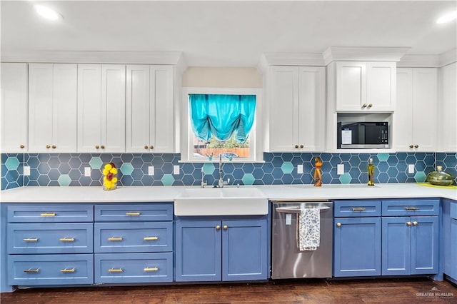 kitchen with light countertops, blue cabinets, appliances with stainless steel finishes, and a sink