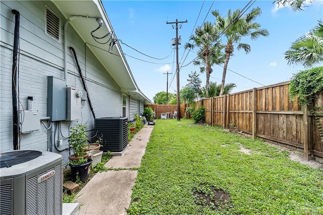 view of yard featuring a fenced backyard and central AC