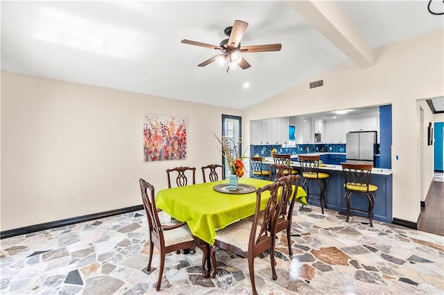 dining room with visible vents, vaulted ceiling with beams, stone finish flooring, and baseboards