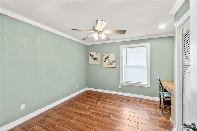 spare room with wood finish floors, baseboards, ornamental molding, and ceiling fan