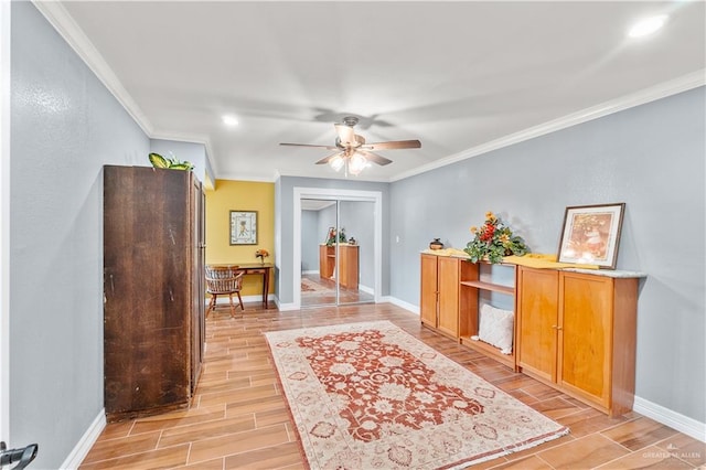 interior space featuring ornamental molding, baseboards, and wood tiled floor