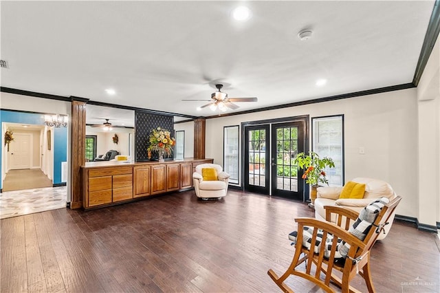 sitting room with dark wood finished floors, french doors, crown molding, and a ceiling fan