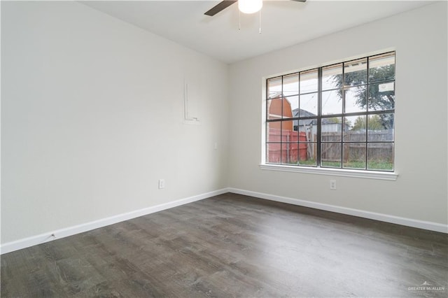 unfurnished room with dark hardwood / wood-style floors and ceiling fan