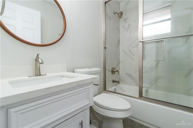 full bathroom with vanity, toilet, and bath / shower combo with glass door