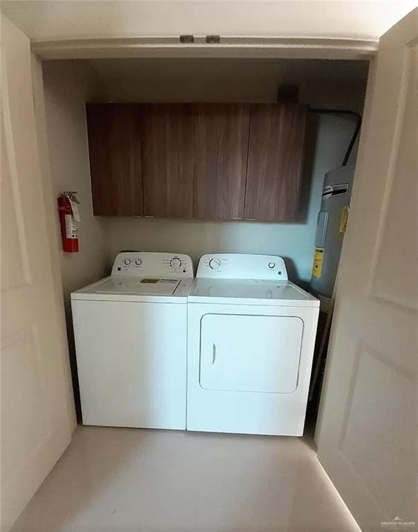 washroom featuring washing machine and dryer and electric water heater