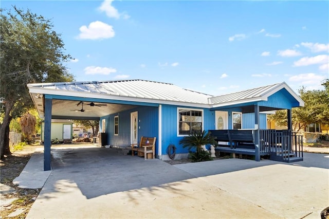 view of front of house with ceiling fan, a porch, and a carport