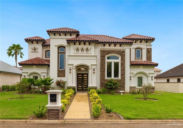 1518 Tierra Bella, Weslaco, TX 78596 - mediterranean / spanish home with stone siding, french doors, stucco siding, and a front yard