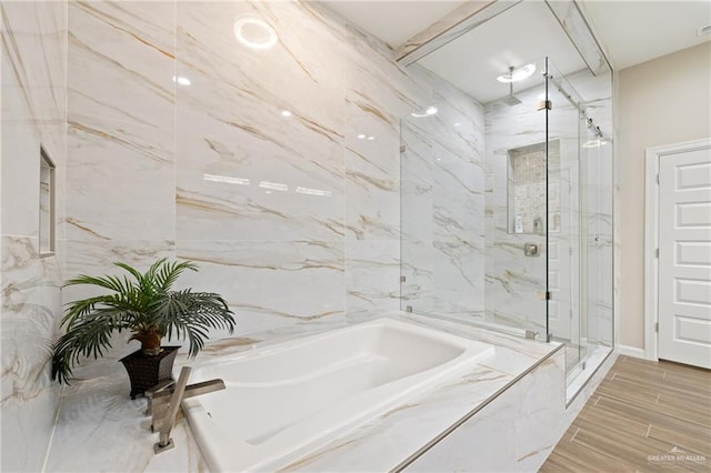 1518 Tierra Bella, Weslaco, TX 78596 - bathroom featuring a marble finish shower, a bath, and wood finished floors