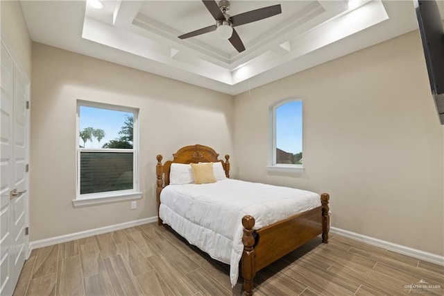 1518 Tierra Bella, Weslaco, TX 78596 - bedroom featuring a tray ceiling, multiple windows, and wood tiled floors