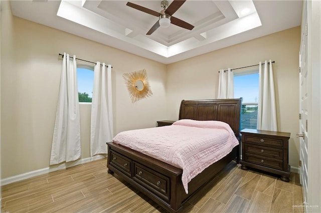 1518 Tierra Bella, Weslaco, TX 78596 - bedroom featuring a tray ceiling, wood tiled floors, multiple windows, and baseboards