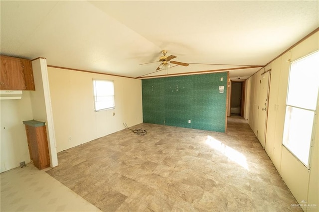 unfurnished living room featuring vaulted ceiling, ceiling fan, and crown molding