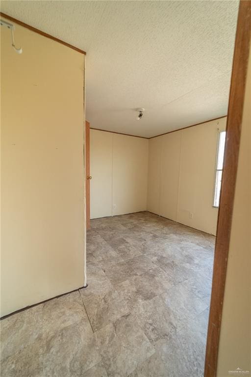 spare room with a textured ceiling