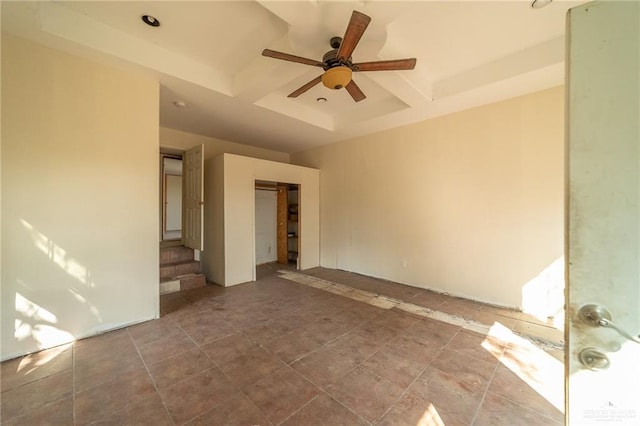 tiled spare room with beamed ceiling and ceiling fan