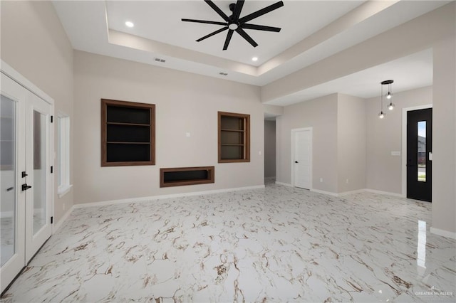 unfurnished living room with baseboards, ceiling fan, recessed lighting, french doors, and a raised ceiling