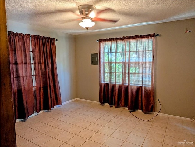 605 8th St, Hidalgo, TX 78557 - spare room with a textured ceiling, ceiling fan, and light tile patterned floors
