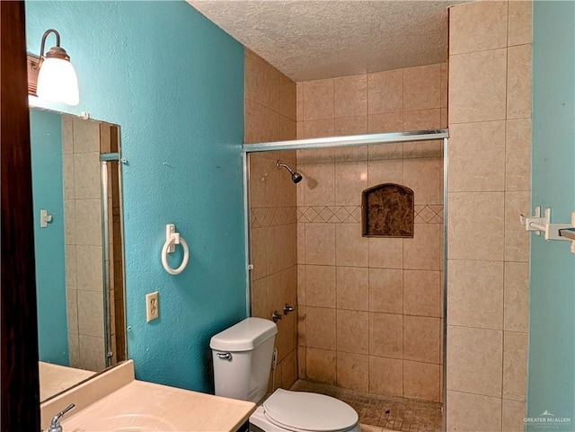 605 8th St, Hidalgo, TX 78557 - bathroom with a shower stall, a textured ceiling, toilet, a textured wall, and vanity