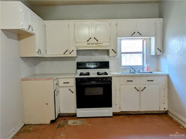 605 8th St, Hidalgo, TX 78557 - kitchen featuring range with gas stovetop, under cabinet range hood, a sink, light countertops, and white cabinets