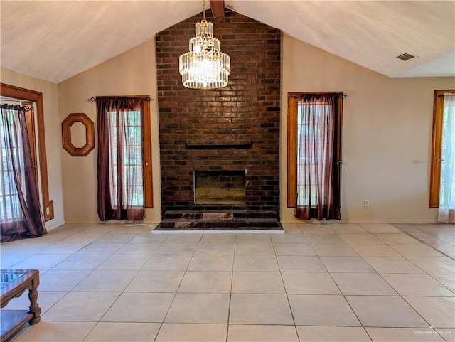 605 8th St, Hidalgo, TX 78557 - unfurnished living room featuring vaulted ceiling, a chandelier, tile patterned floors, a brick fireplace, and baseboards