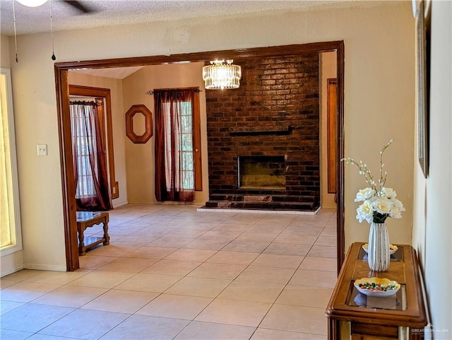 605 8th St, Hidalgo, TX 78557 - living room with light tile patterned floors, healthy amount of natural light, a chandelier, a brick fireplace, and a textured ceiling