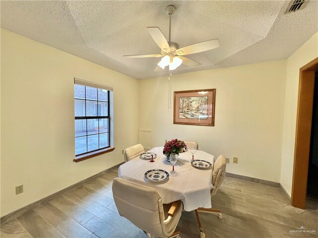 kitchen with a textured ceiling, stainless steel appliances, and ceiling fan