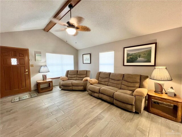 unfurnished living room with ceiling fan, a textured ceiling, light hardwood / wood-style flooring, and vaulted ceiling with beams