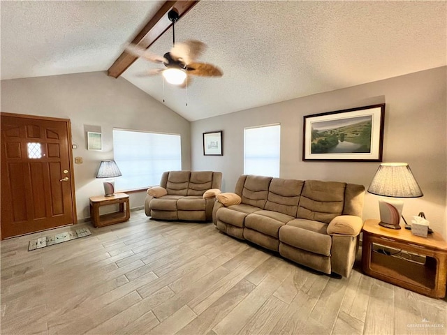 living room with vaulted ceiling with beams, light hardwood / wood-style floors, a textured ceiling, and ceiling fan