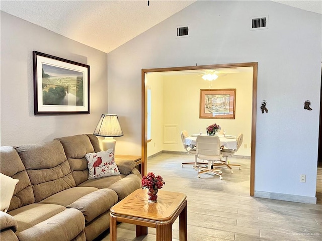 living room with vaulted ceiling and light wood-type flooring