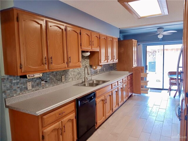 kitchen featuring sink, decorative backsplash, black dishwasher, and ceiling fan