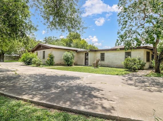 131 N Missouri Ave, Mercedes, TX 78570 - view of front facade with brick siding and driveway
