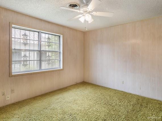 131 N Missouri Ave, Mercedes, TX 78570 - spare room with ceiling fan, carpet flooring, a textured ceiling, and visible vents
