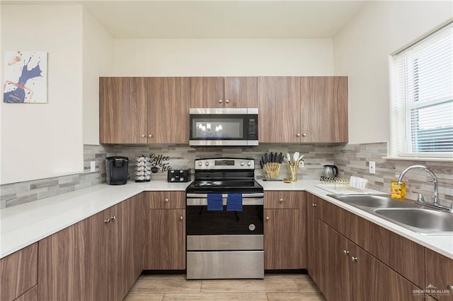 kitchen featuring tasteful backsplash, sink, a wealth of natural light, and stainless steel appliances