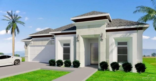 view of front of property featuring a front yard and a garage