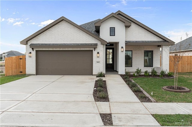 view of front of house with a garage and a front yard