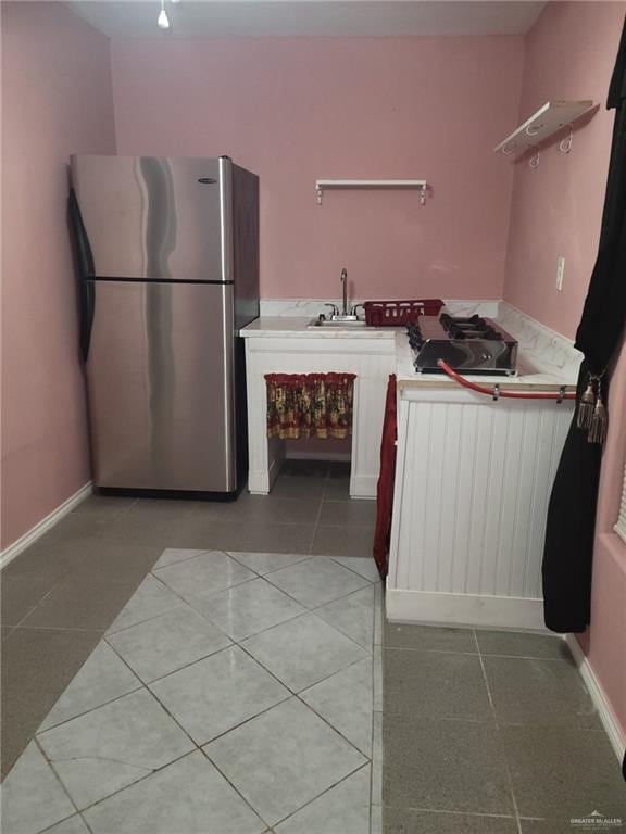 3300 Pradera St, Mission, TX 78574 - kitchen with freestanding refrigerator, a sink, light tile patterned floors, open shelves, and light countertops