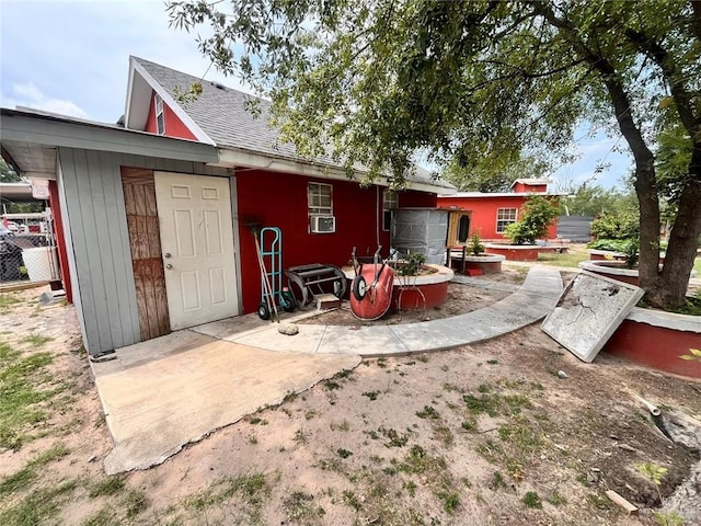 3300 Pradera St, Mission, TX 78574 - back of property with a shingled roof and cooling unit
