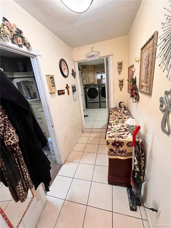 3300 Pradera St, Mission, TX 78574 - hall featuring washing machine and clothes dryer and light tile patterned floors