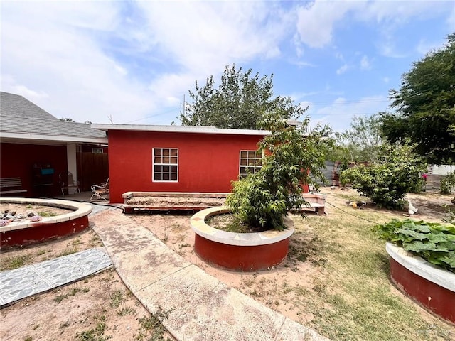 3300 Pradera St, Mission, TX 78574 - rear view of property featuring stucco siding and a lawn