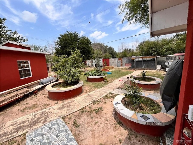 3300 Pradera St, Mission, TX 78574 - fenced yard with a vegetable garden