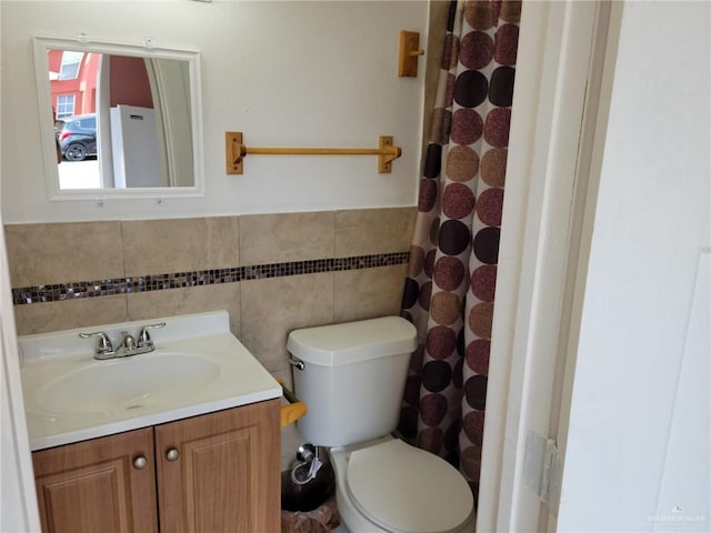 3300 Pradera St, Mission, TX 78574 - full bath with vanity, toilet, wainscoting, tile walls, and curtained shower