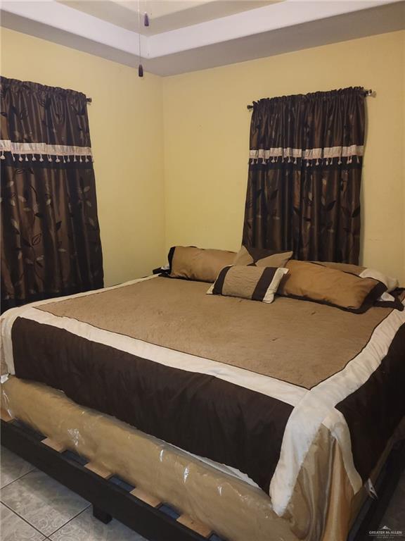 3300 Pradera St, Mission, TX 78574 - bedroom with a raised ceiling and tile patterned floors