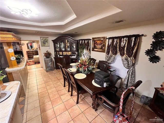 3300 Pradera St, Mission, TX 78574 - dining area featuring a tray ceiling and light tile patterned flooring