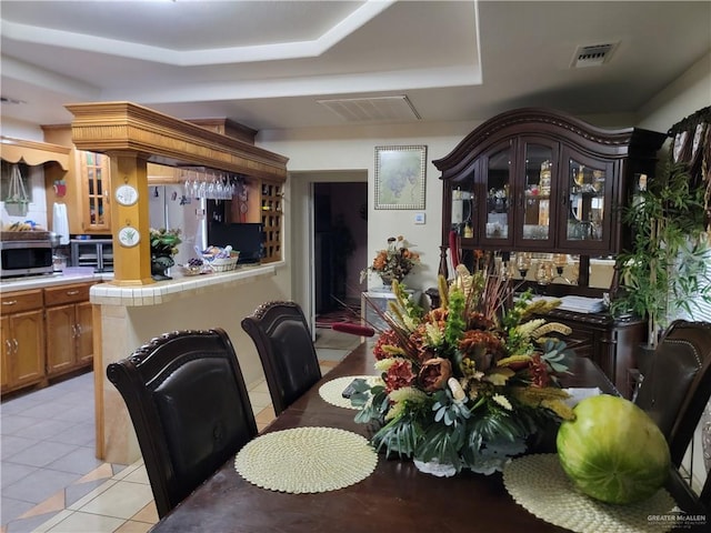 3300 Pradera St, Mission, TX 78574 - dining space featuring a tray ceiling and light tile patterned floors