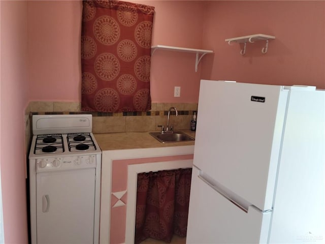 3300 Pradera St, Mission, TX 78574 - kitchen featuring white appliances, open shelves, a sink, and light countertops