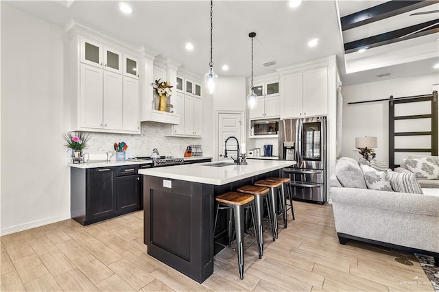 16593 W Mccullar Ct, Harlingen, TX 78552 - kitchen with stainless steel appliances, a sink, light countertops, a kitchen breakfast bar, and recessed lighting