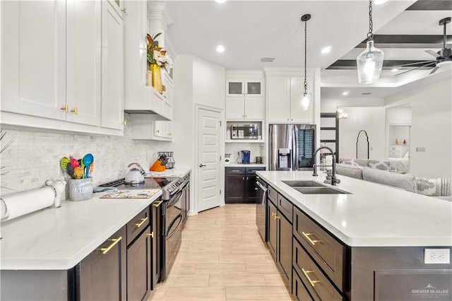 16593 W Mccullar Ct, Harlingen, TX 78552 - kitchen featuring a sink, stainless steel appliances, white cabinetry, a center island with sink, and tasteful backsplash