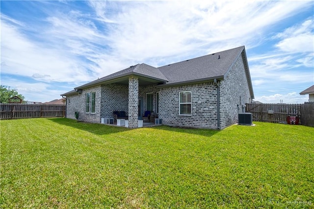 16593 W Mccullar Ct, Harlingen, TX 78552 - back of house with brick siding, a patio, central air condition unit, and roof with shingles